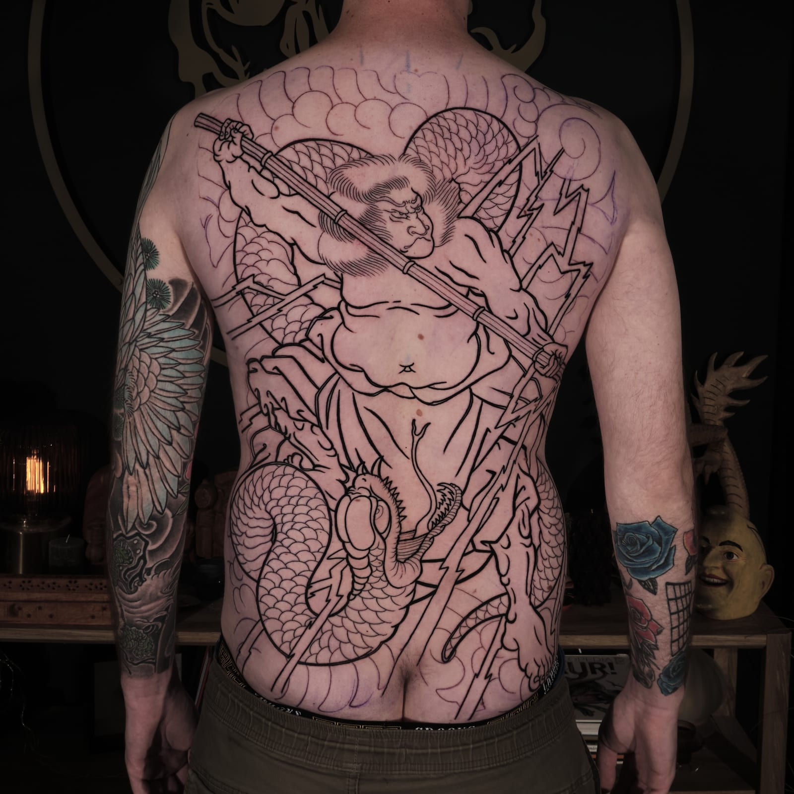 Japanese back tattoo outline featuring a monkey warrior with a staff, snake and lightning.
