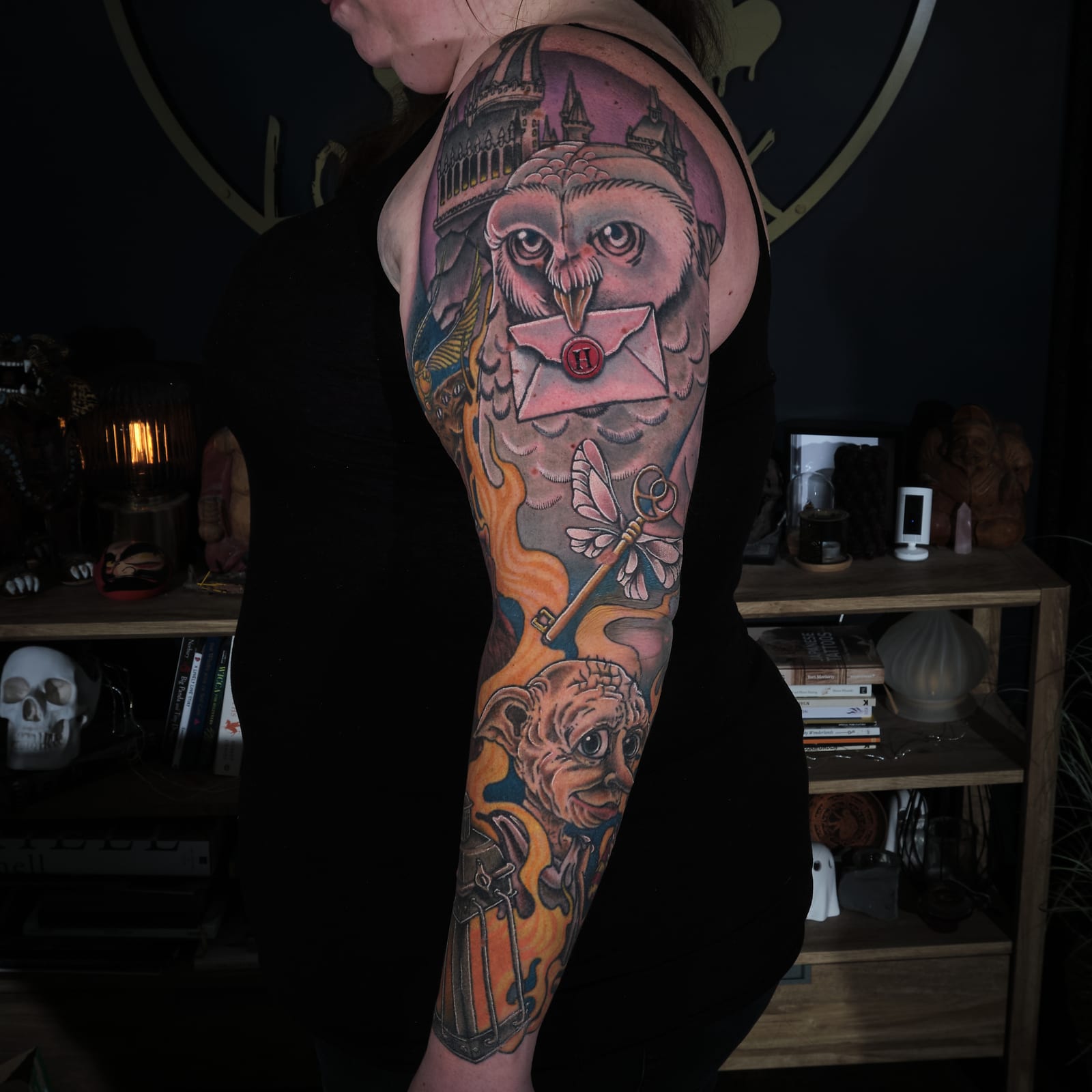 Colour Harry Potter sleeve tattoo with an owl carrying a letter, Hogwarts, flying keys and Dobby.