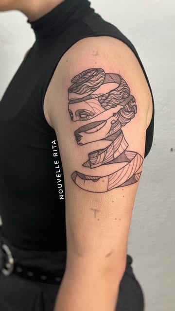 Abstract fine-line classical portrait tattoo formed from ribbon-like sections on an upper arm.